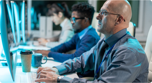 man sitting on comptuter